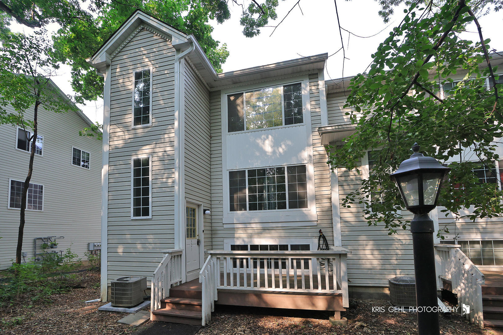 321 West Whispering Oaks Lane, Unit 321 Round Lake, IL 60073 - Photo 1 of 15 a balcony with furniture and a potted plant