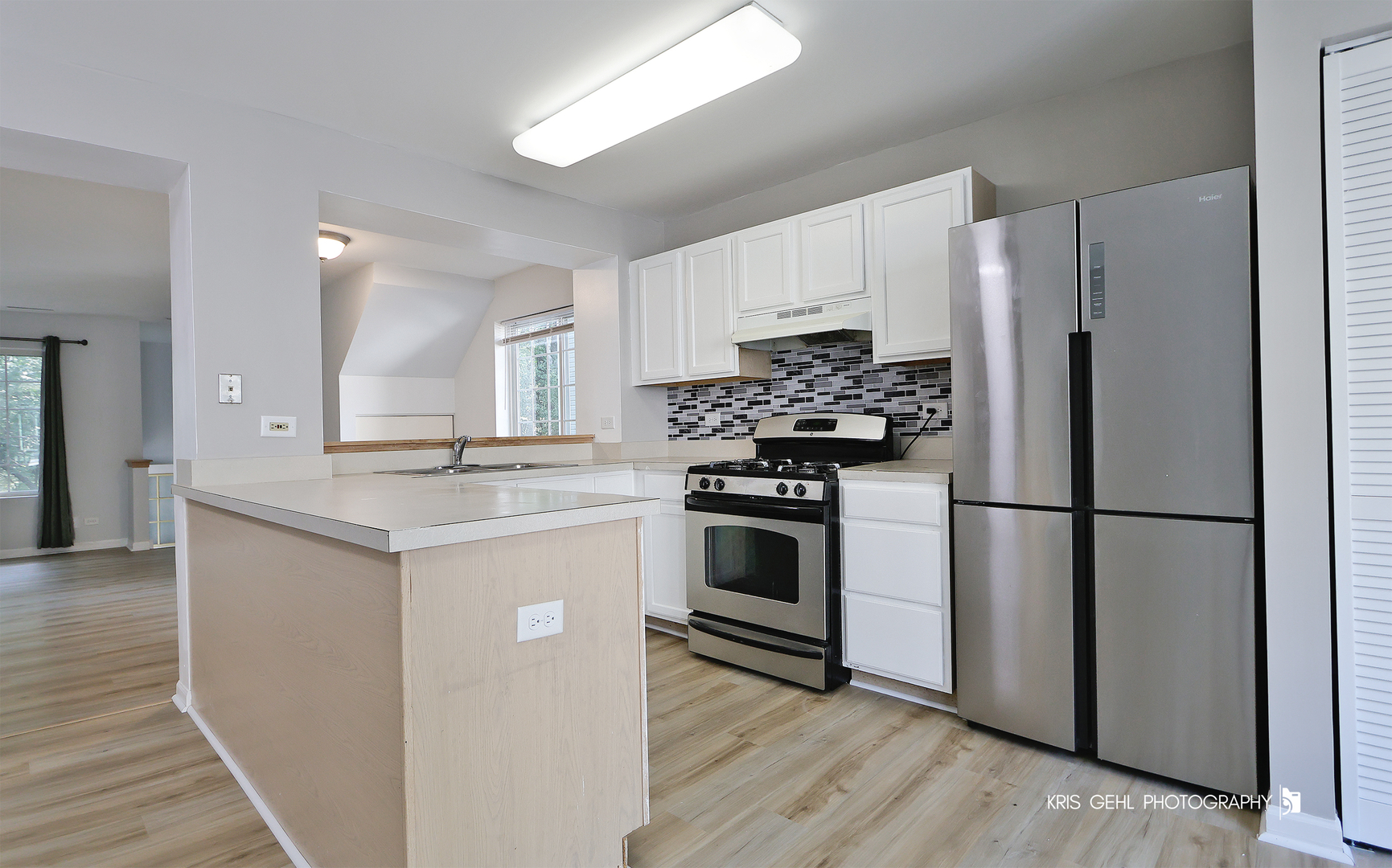 321 West Whispering Oaks Lane, Unit 321 Round Lake, IL 60073 - Photo 9 of 15 a kitchen with white cabinets and white appliances