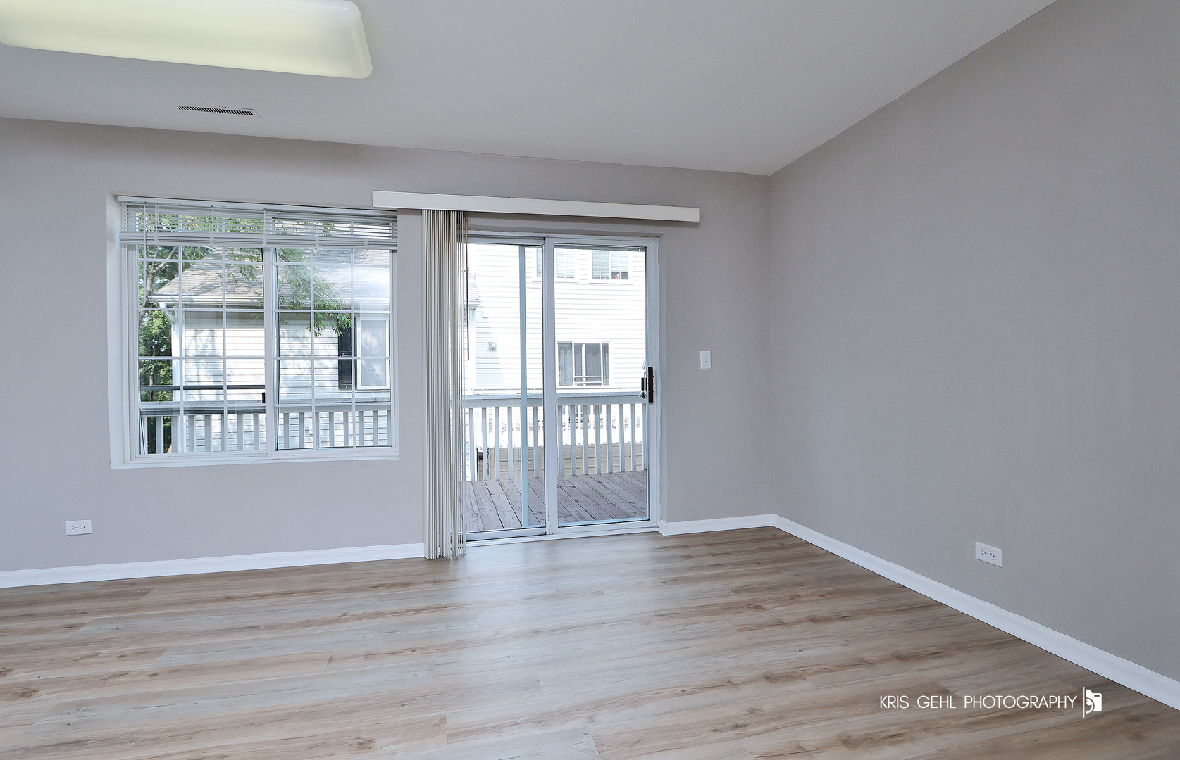 321 West Whispering Oaks Lane, Unit 321 Round Lake, IL 60073 - Photo 6 of 15 a view of an empty room with wooden floor and a window