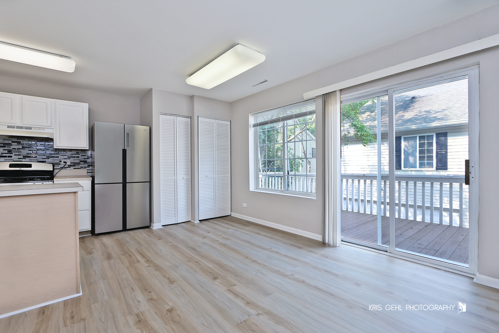 321 West Whispering Oaks Lane, Unit 321 Round Lake, IL 60073 - Photo 7 of 15 a view of a kitchen with a stove cabinets and wooden floor