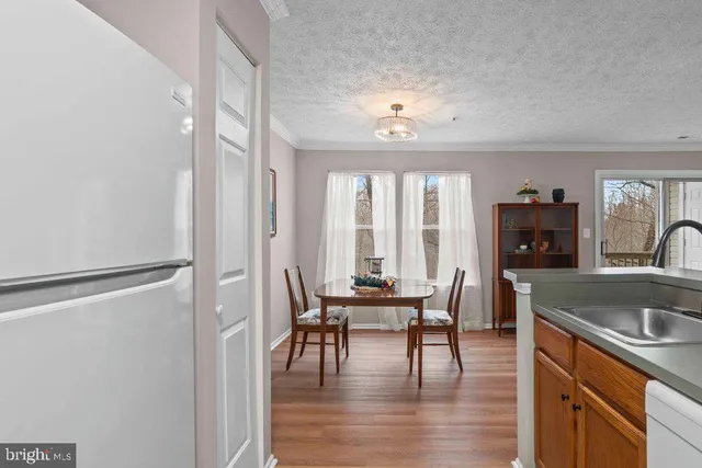 a view of a a dining room with furniture window and wooden floor