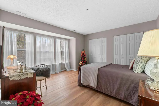 a spacious bedroom with two beds and a closet