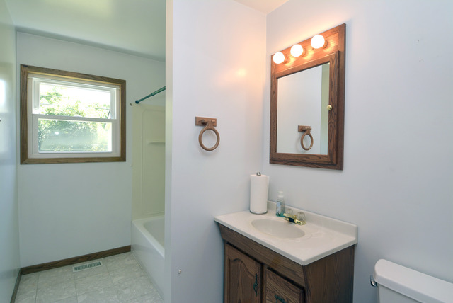 370 Dunbar Road Wauconda, IL 60084 - Photo 18 of 22 a bathroom with a sink and a mirror