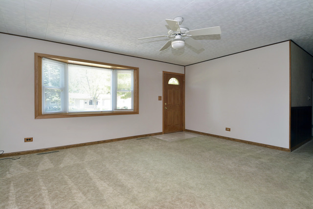 370 Dunbar Road Wauconda, IL 60084 - Photo 2 of 22 an empty room with windows and fan