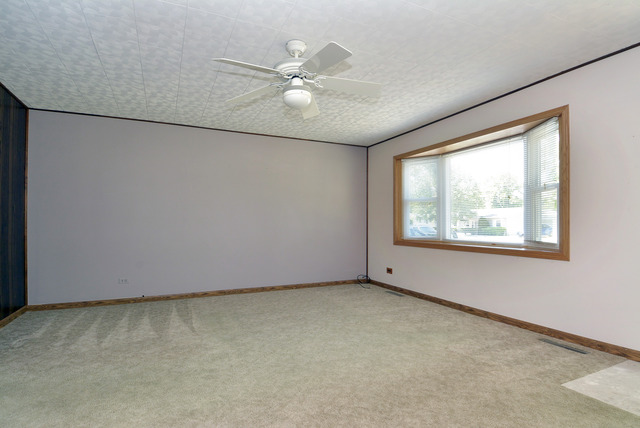 370 Dunbar Road Wauconda, IL 60084 - Photo 3 of 22 an empty room with windows and fan