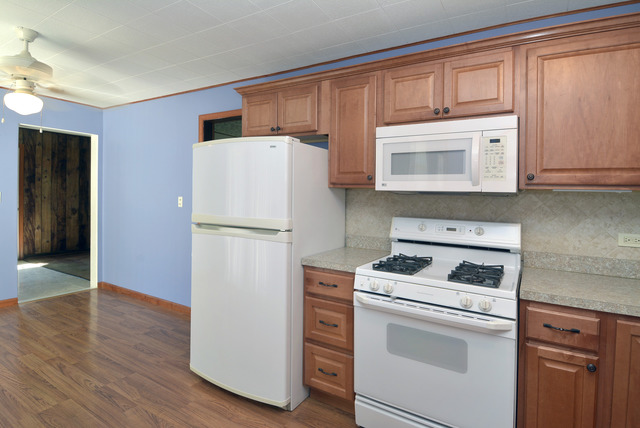 370 Dunbar Road Wauconda, IL 60084 - Photo 5 of 22 a kitchen with a refrigerator stove and cabinets