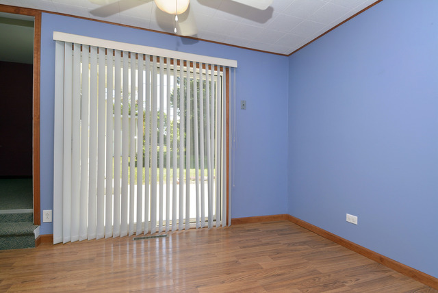 370 Dunbar Road Wauconda, IL 60084 - Photo 7 of 22 a view of an empty room with wooden floor and a window