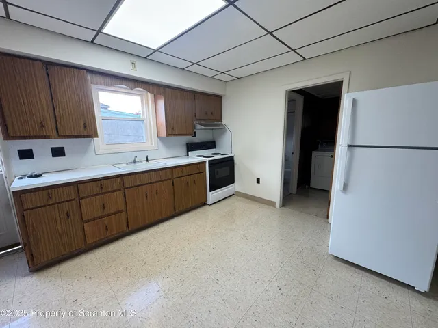 a kitchen with a sink a refrigerator and a stove