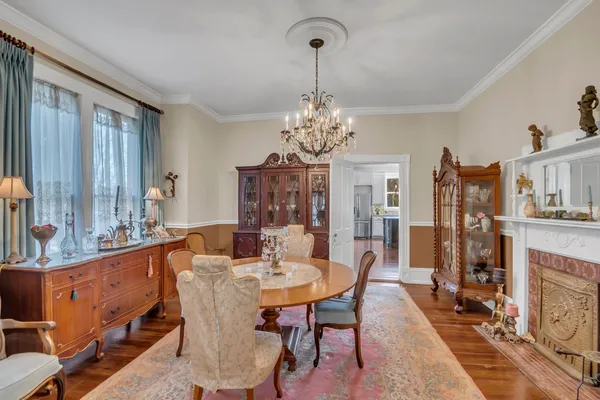 a view of a dining room with furniture and a chandelier