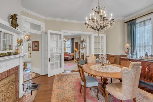 a view of a dining room with furniture and chandelier