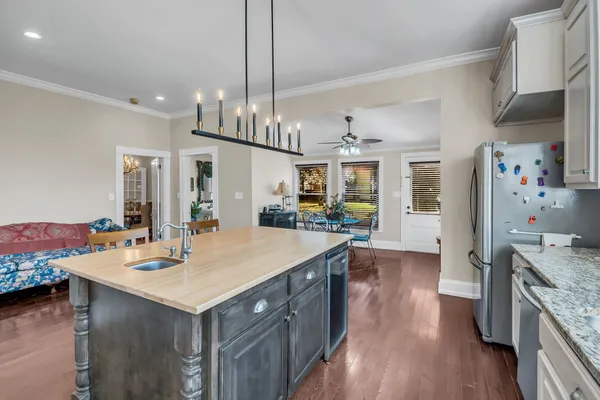 a kitchen with stainless steel appliances a sink stove and refrigerator