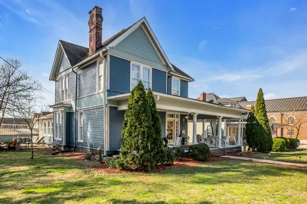 a front view of a house with a yard table and chairs