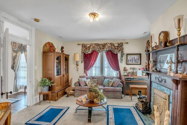 a living room with furniture a rug and a lamp