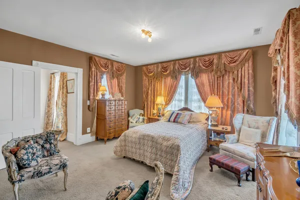a bedroom with a bed and a couch