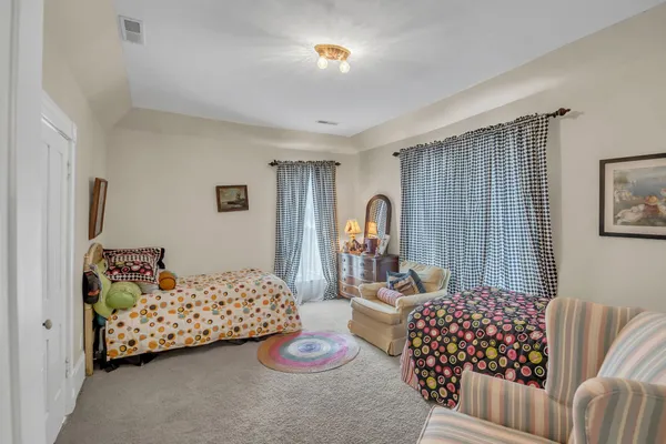 a bedroom with bed and a chandelier