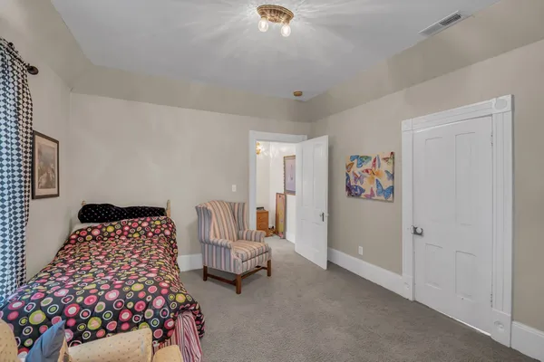 a bedroom with furniture and a window