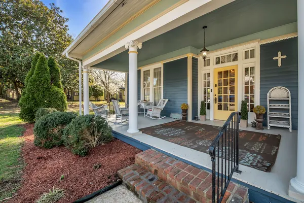 a view of an house with backyard porch and furniture