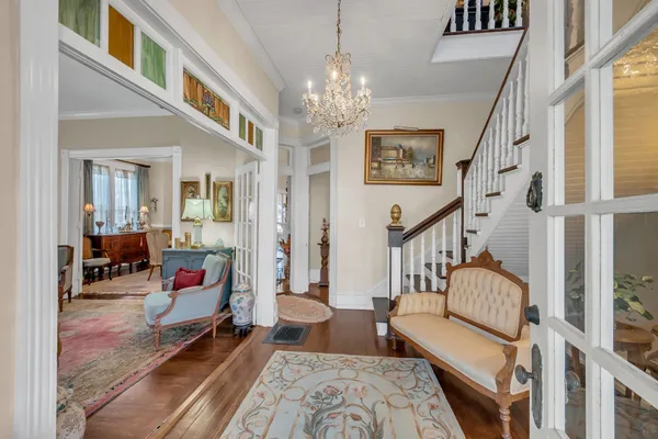 a living room with furniture and a chandelier
