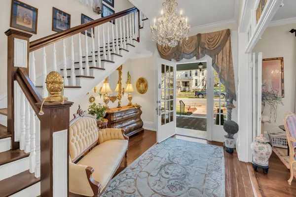 a living room with furniture and a chandelier