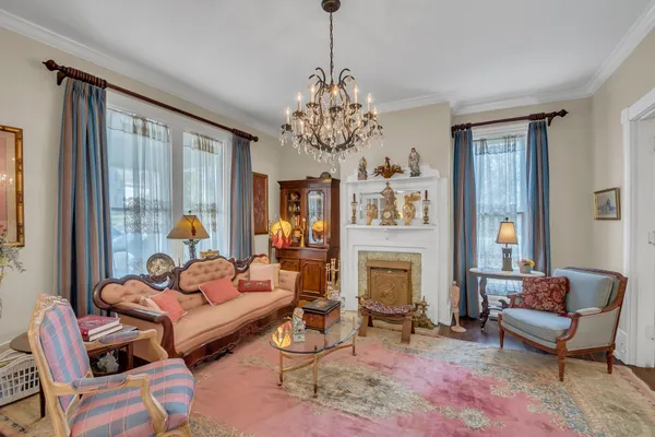 a living room with furniture fireplace and a large window