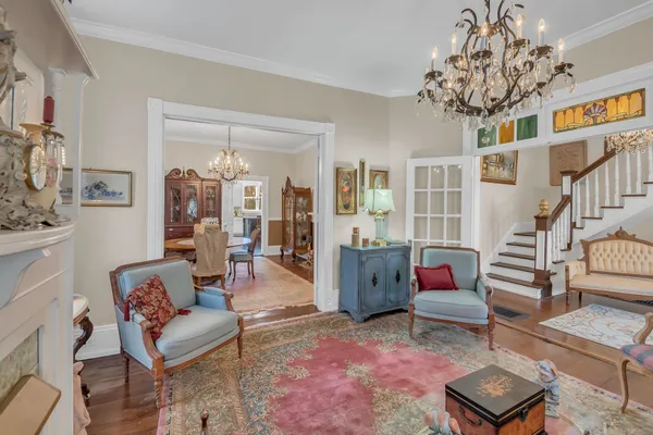 a living room with furniture and a chandelier
