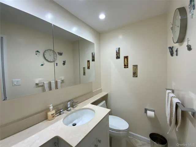a bathroom with a sink a toilet and mirror