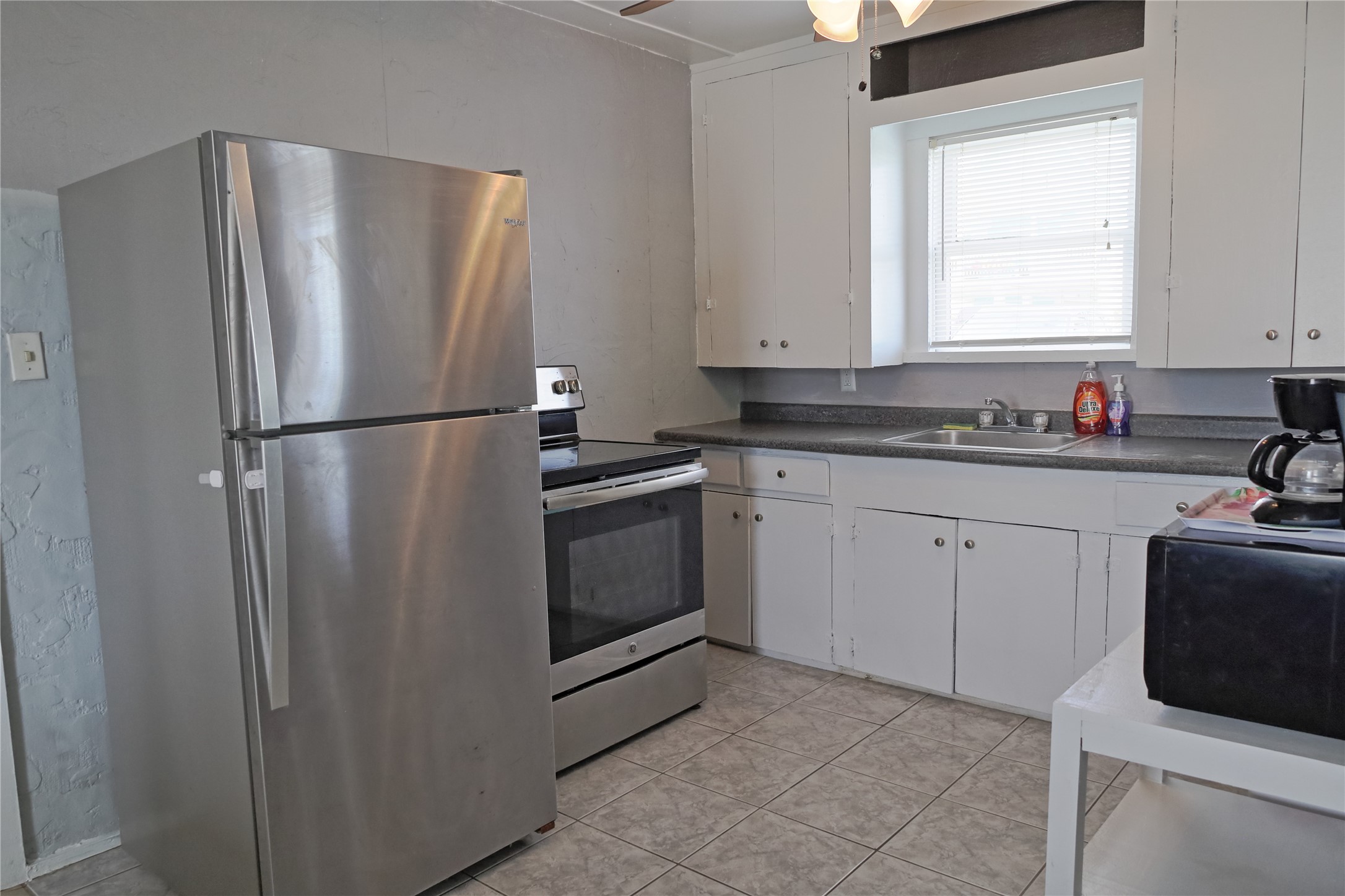 419 Murex Street Surfside Beach, TX 77541 - Photo 11 of 17 a white refrigerator freezer sitting inside of a kitchen with stainless steel appliances granite countertop cabinets and a refrigerator