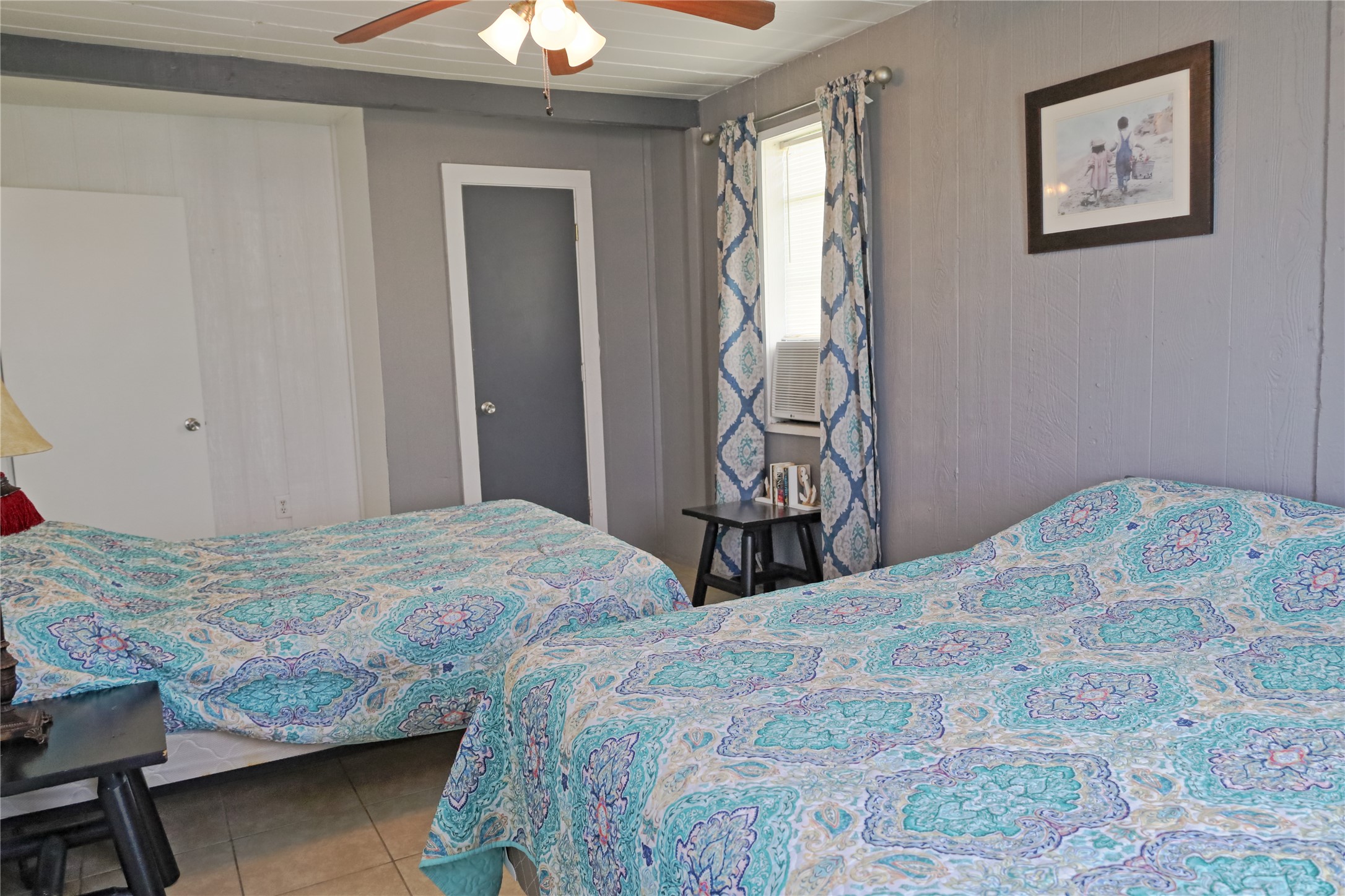 419 Murex Street Surfside Beach, TX 77541 - Photo 12 of 17 a bedroom with a bed and a chandelier