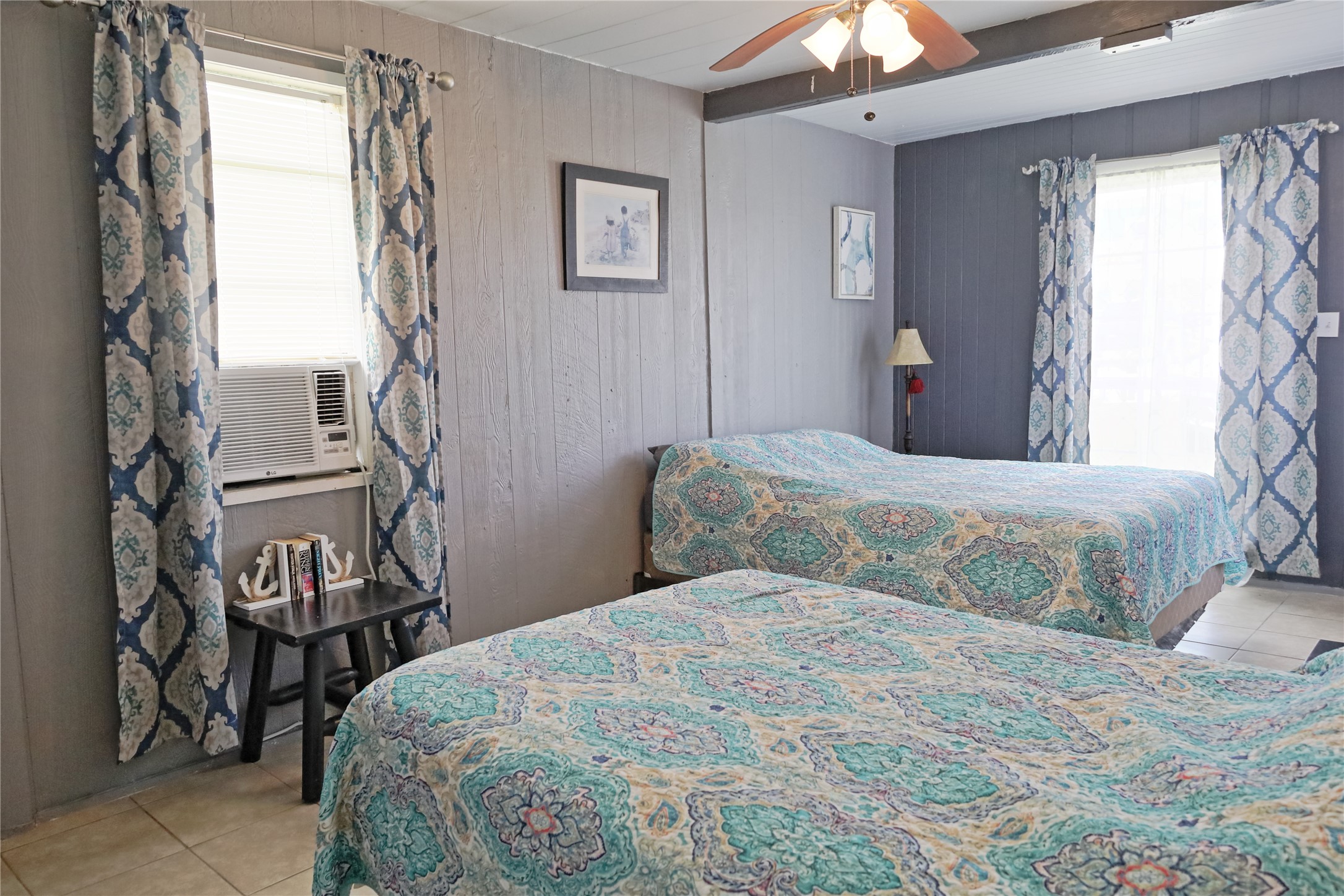 419 Murex Street Surfside Beach, TX 77541 - Photo 14 of 17 a bedroom with a bed and a chandelier