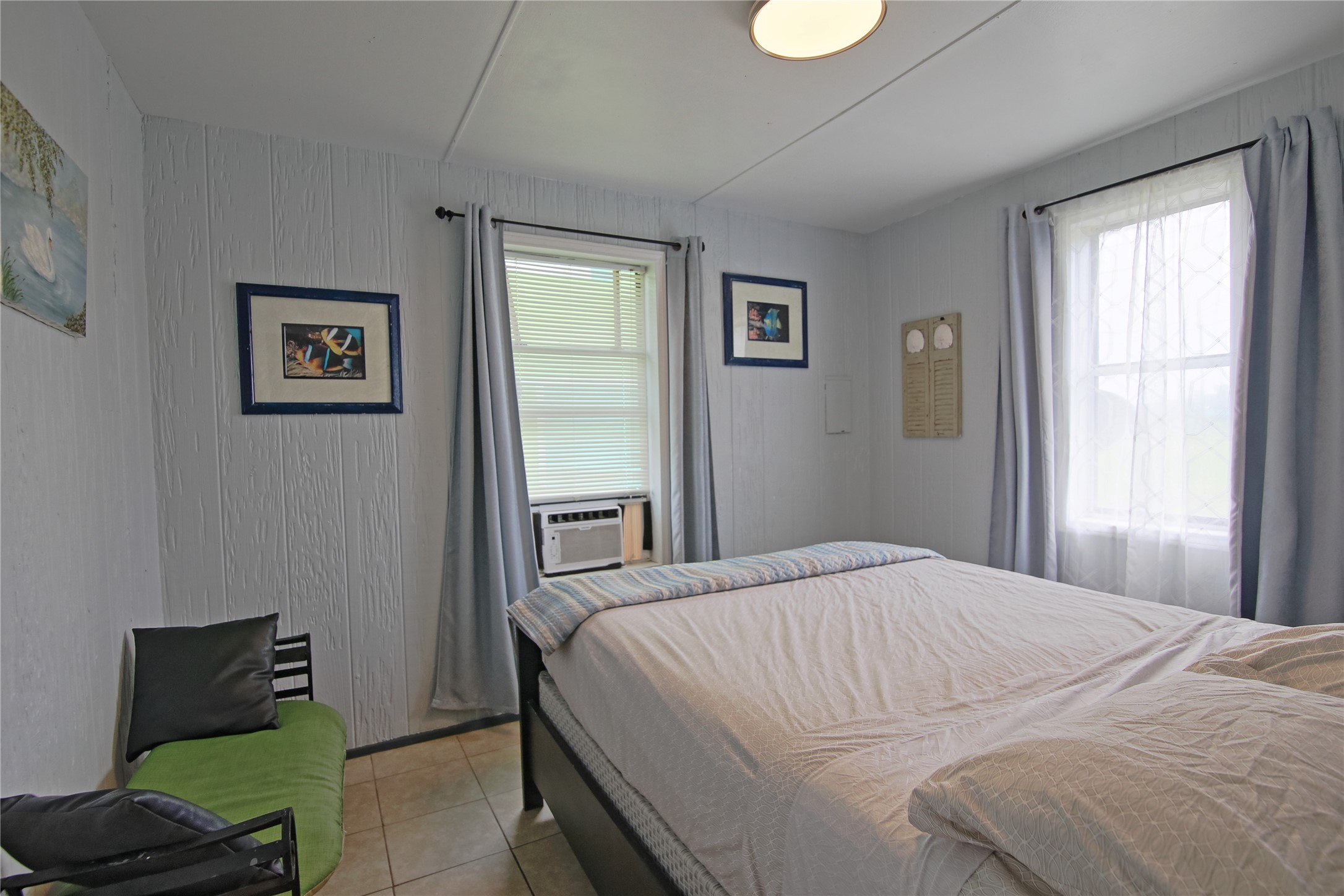 419 Murex Street Surfside Beach, TX 77541 - Photo 16 of 17 a bedroom with a bed and wooden floor