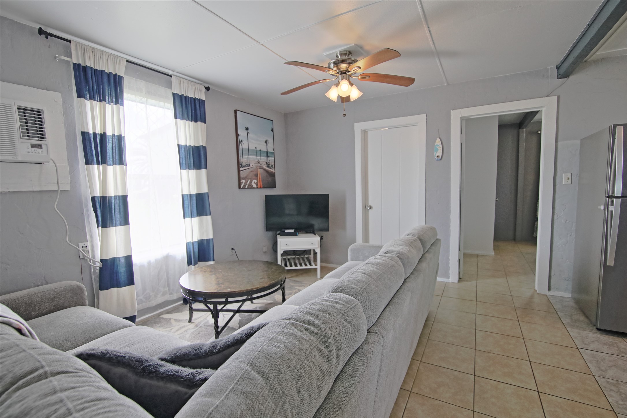 419 Murex Street Surfside Beach, TX 77541 - Photo 4 of 17 a living room with furniture and a chandelier