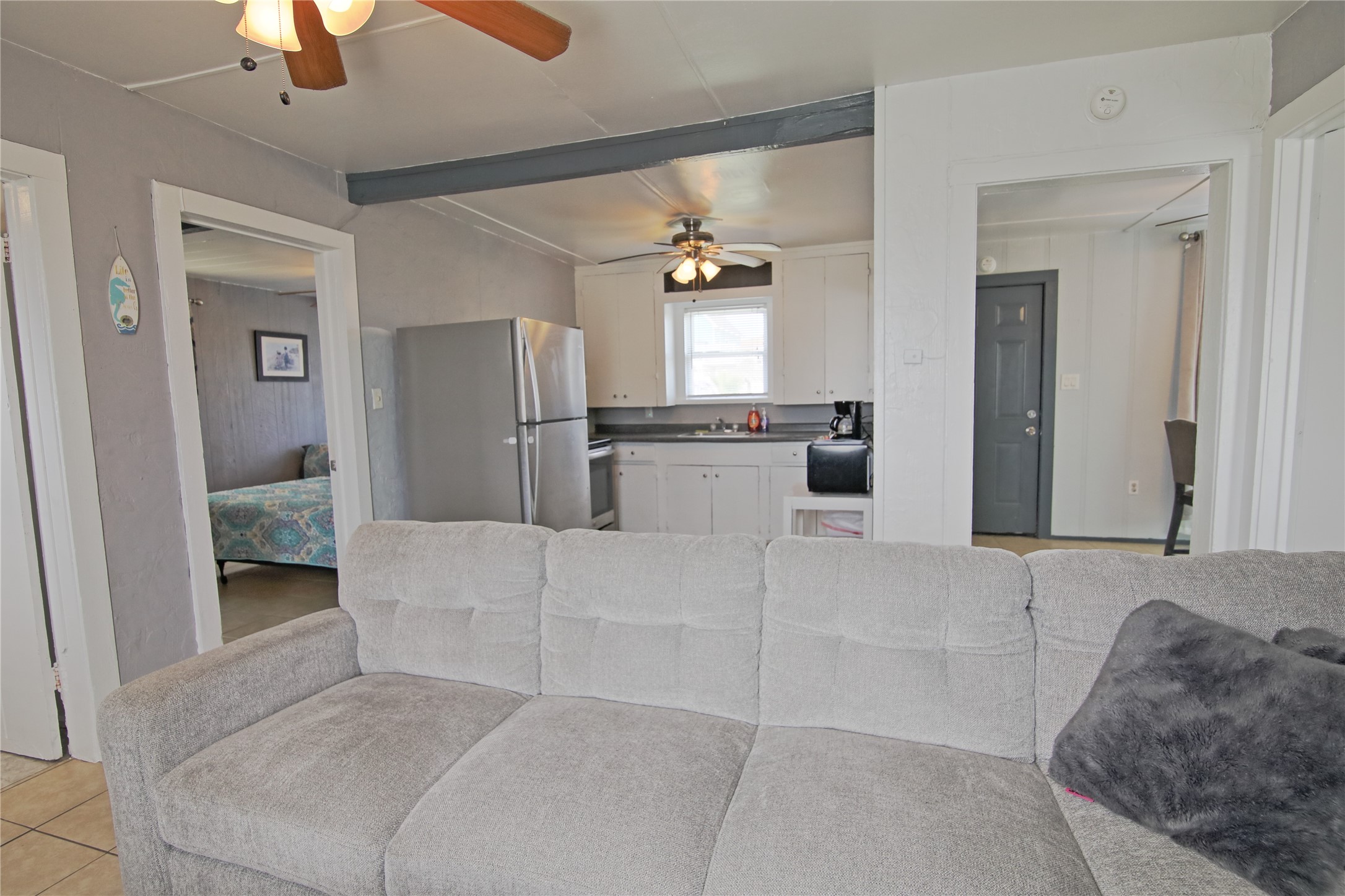 419 Murex Street Surfside Beach, TX 77541 - Photo 6 of 17 a living room with furniture and a chandelier