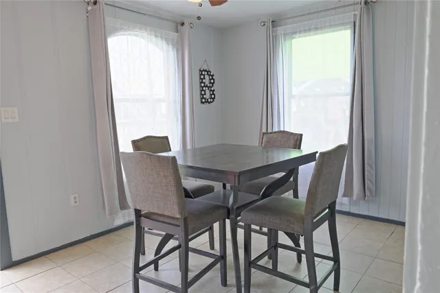 a view of a dining room with furniture and a window