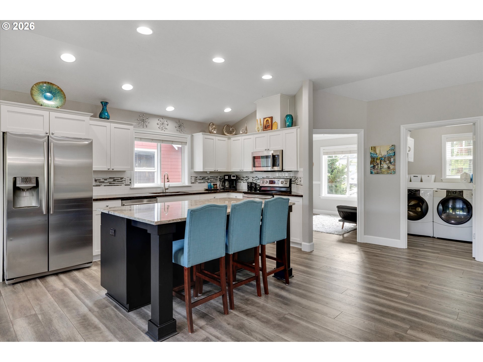 3769 10th Street Hubbard, OR 97032 - Photo 12 of 47 a kitchen with stainless steel appliances granite countertop a table chairs refrigerator and sink