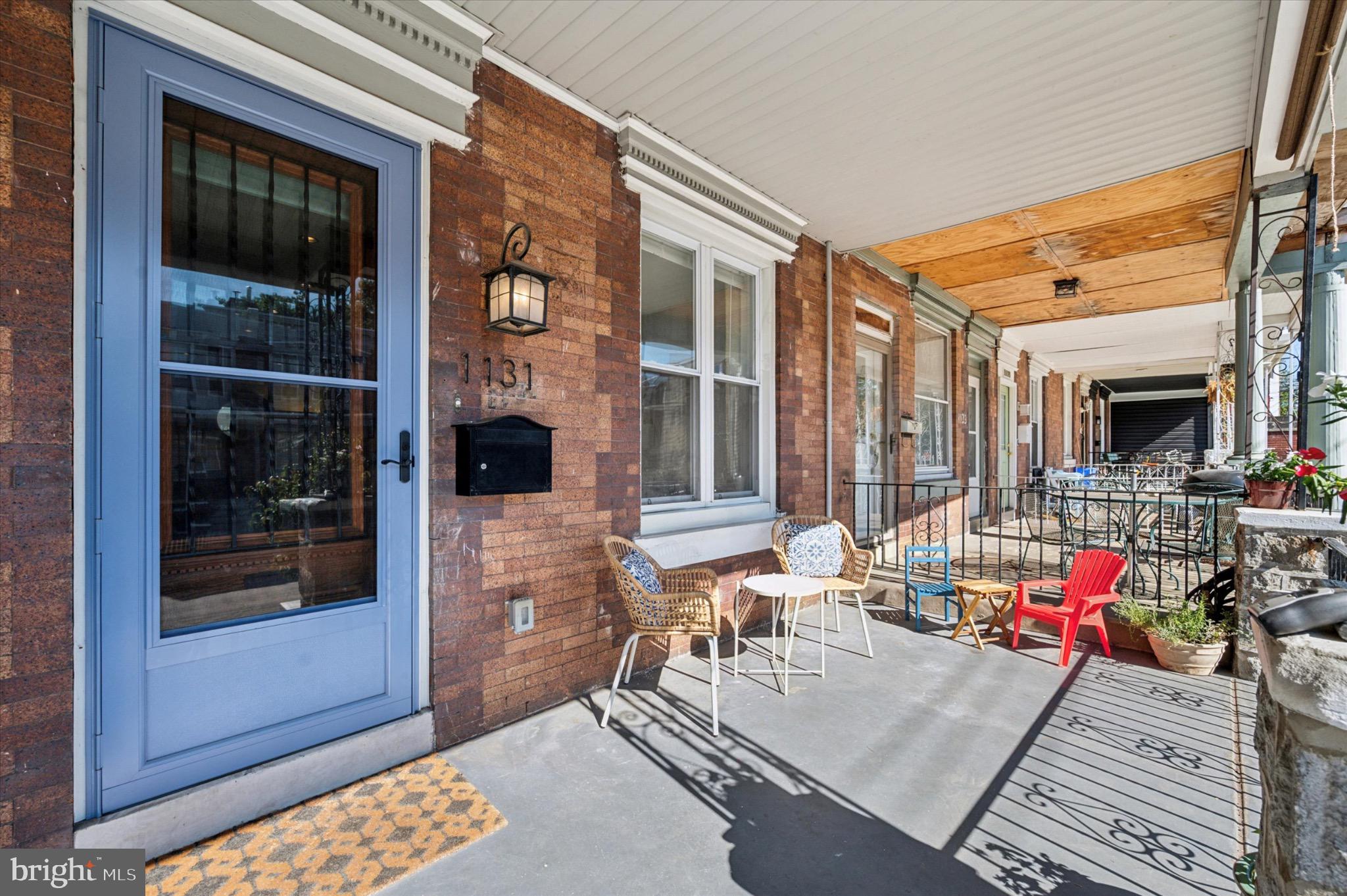 1131 Divinity Street Philadelphia, PA 19143 - Photo 3 of 38 Charming porch with inviting brick facade.