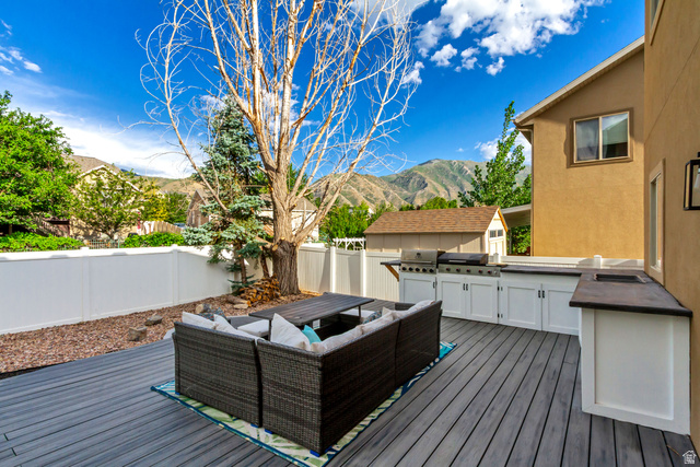 1585 South 910 West Payson, UT 84651 - Photo 25 of 32 Expansive outdoor deck featuring wood-finish decking, a built-in outdoor kitchen with integrated grill, and white cabinetry