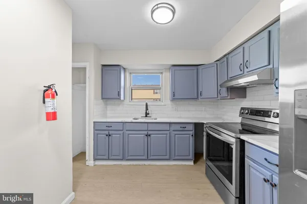 a kitchen with stainless steel appliances granite countertop a sink and a stove