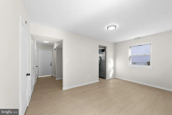 an empty room with windows and closet