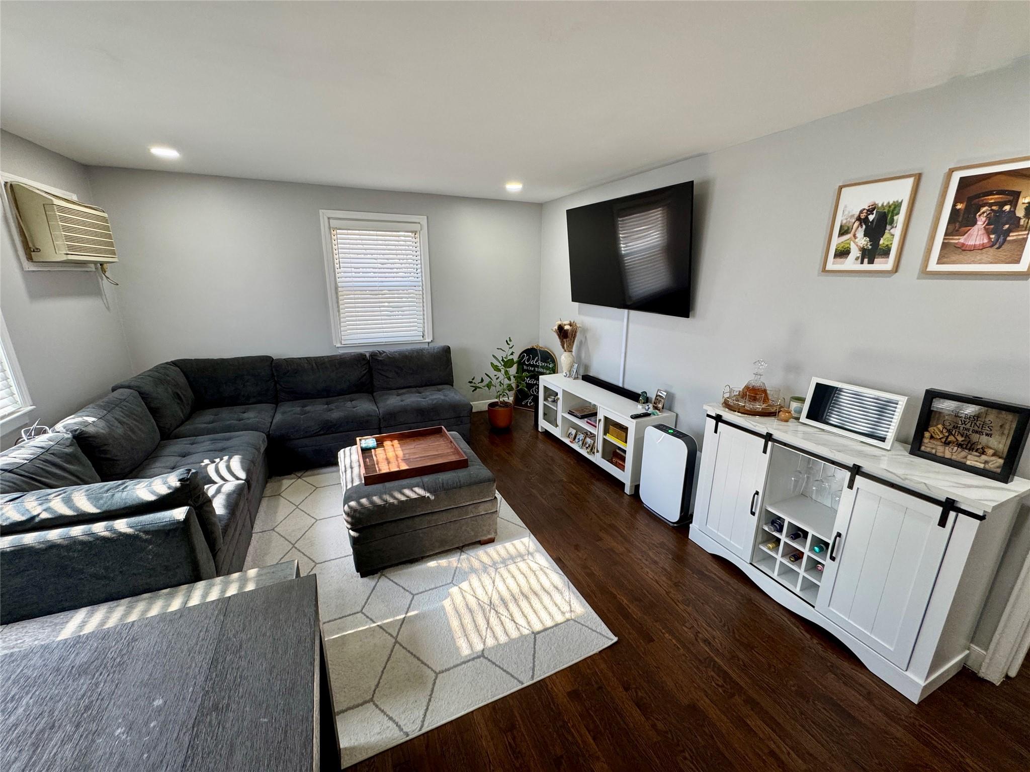 268-01 83rd New Hyde Park, NY 11040 - Photo 1 of 1 a living room with furniture and a flat screen tv