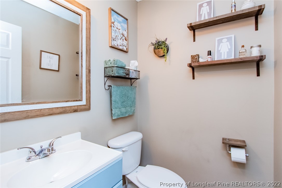 471 United Road Raeford, NC 28376 - Photo 14 of 31 a bathroom with a toilet sink and mirror