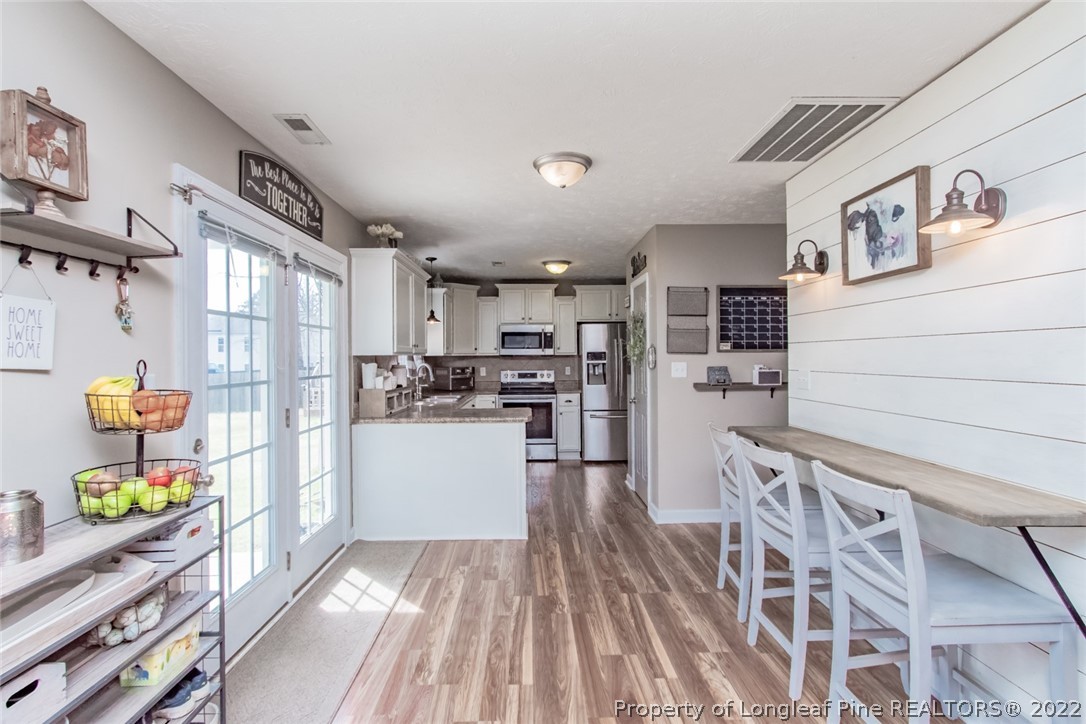 471 United Road Raeford, NC 28376 - Photo 5 of 31 a kitchen with stainless steel appliances granite countertop a refrigerator and a stove top oven