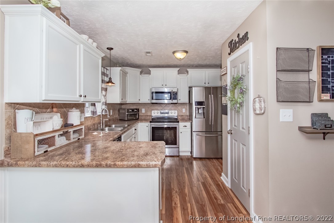 471 United Road Raeford, NC 28376 - Photo 6 of 31 a kitchen with kitchen island granite countertop stainless steel appliances and a counter top space