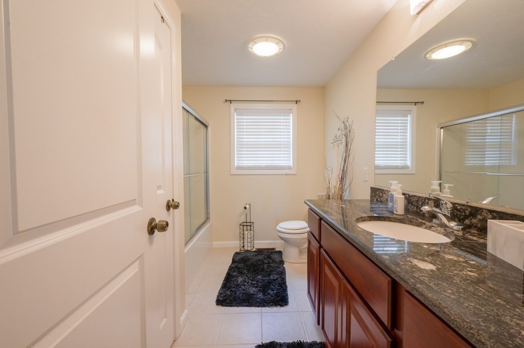 408 Sunderland Road Worcester, MA 01604 - Photo 7 of 24 a bathroom with a granite countertop sink a toilet and shower
