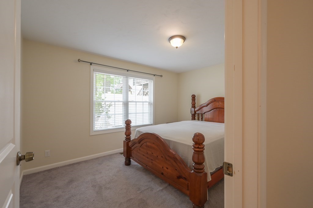 408 Sunderland Road Worcester, MA 01604 - Photo 8 of 24 a bed room with a bed and a window