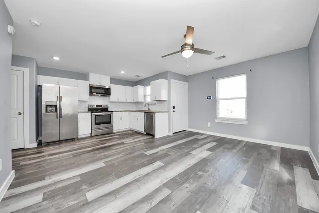 a large kitchen with cabinets and stainless steel appliances