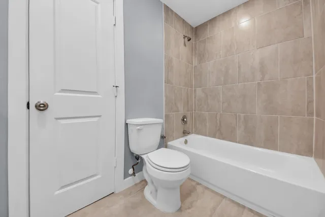 a bathroom with a toilet and a bathtub