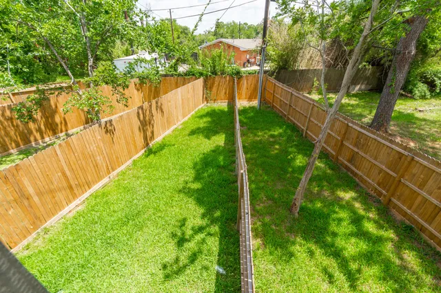 a view of a yard with large trees