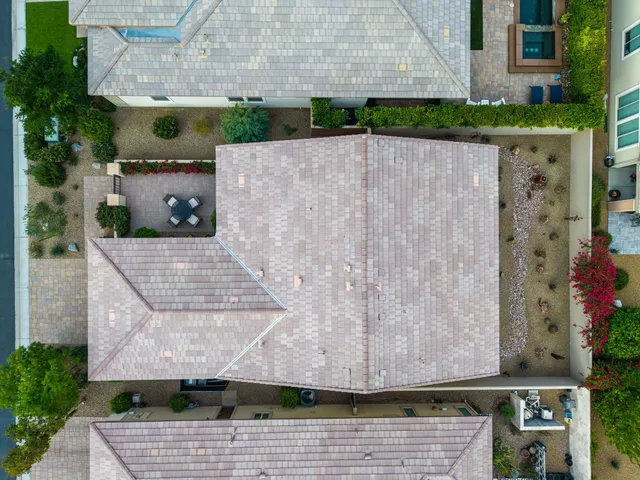 a aerial view of a house with a yard and potted plants