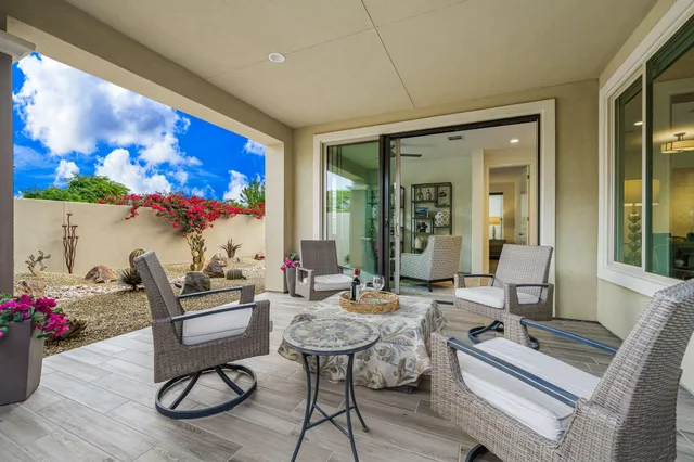 a living room with furniture a floor to ceiling window and a flat screen tv