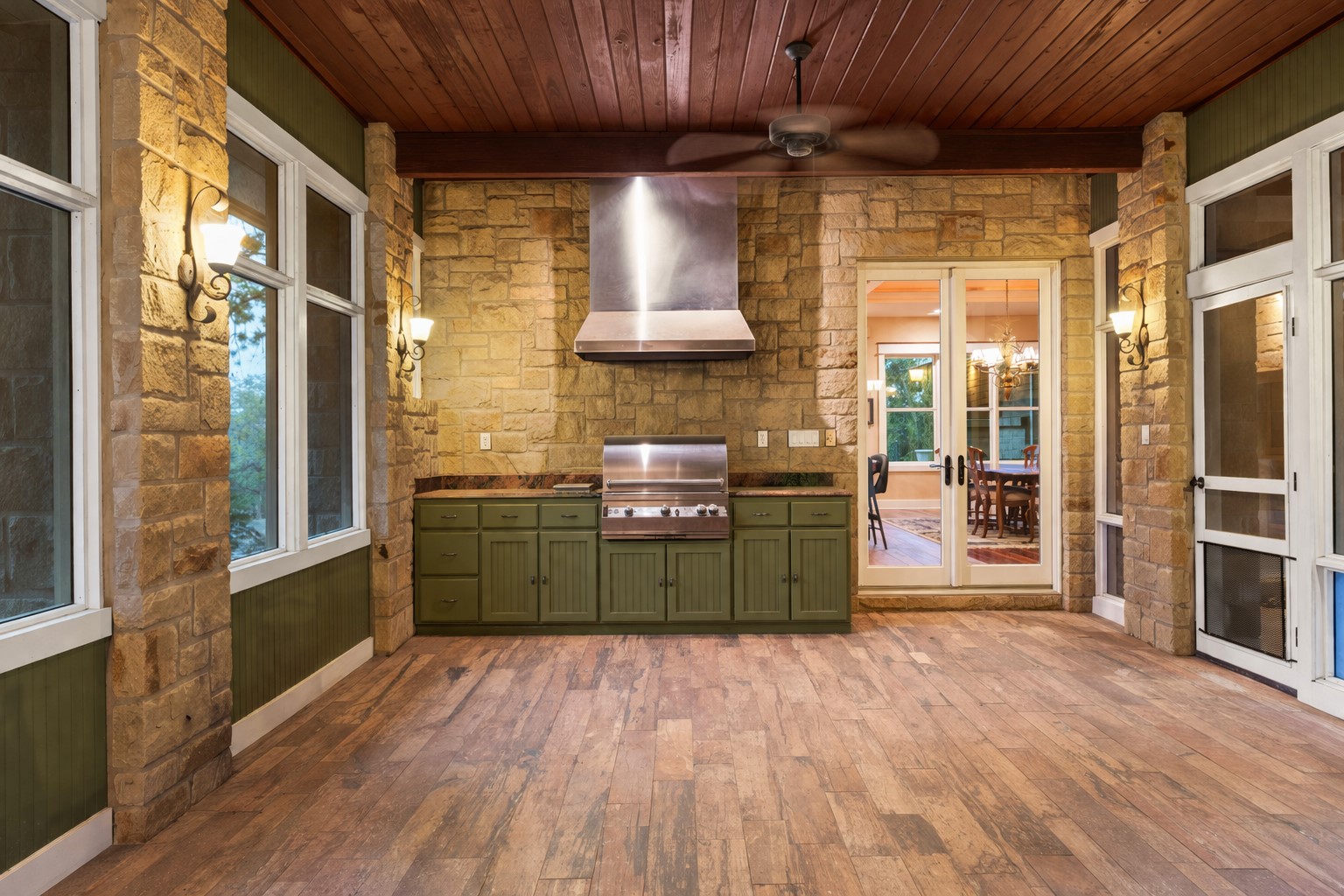 23426 Oscar Road Spicewood, TX 78669 - Photo 20 of 40 View of the built-in grill in the screened-in porch facing into the house. a tongue and grove cypress cetiling has exposed wood beams.
